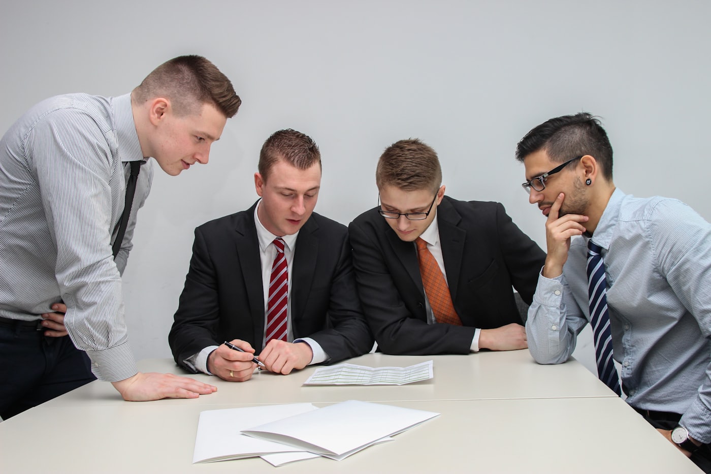Four colleagues examining a document together at a table